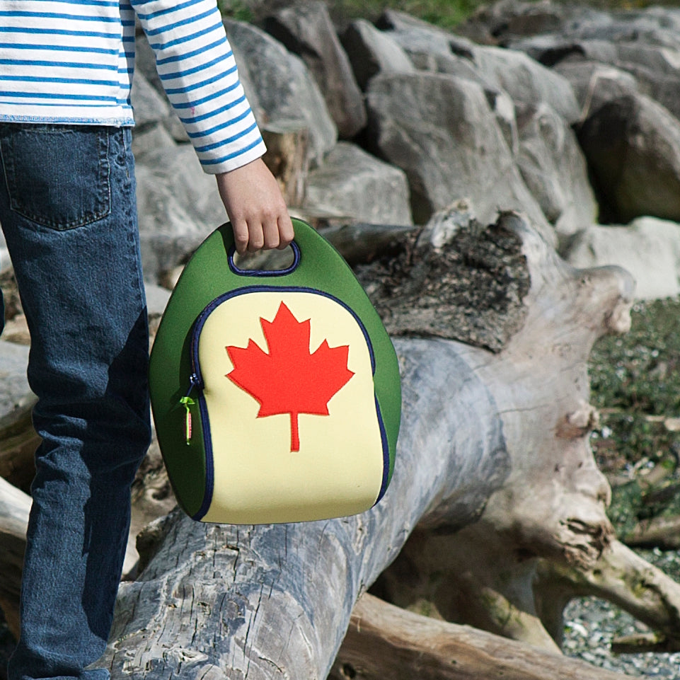 Girl holding a lunch bag with a lady bug on it